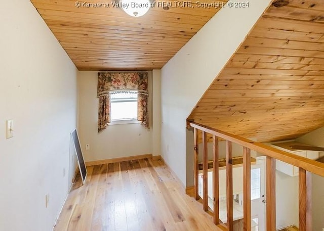 bonus room featuring vaulted ceiling, light hardwood / wood-style flooring, and wooden ceiling