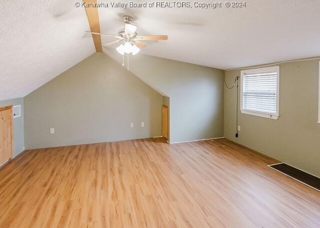 additional living space featuring ceiling fan, light hardwood / wood-style flooring, and lofted ceiling