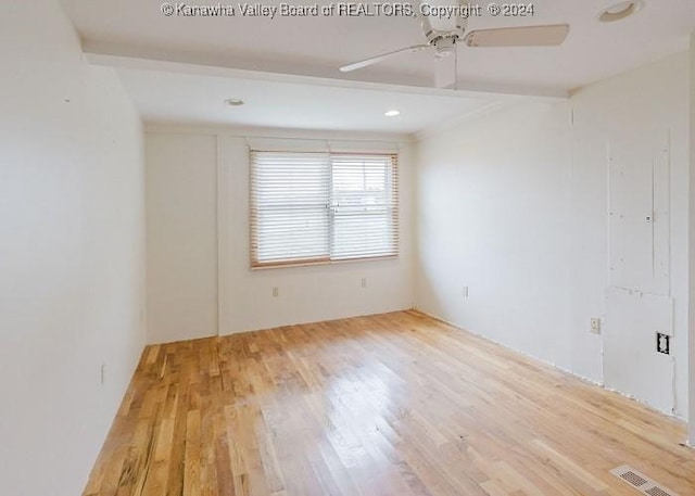 spare room featuring light hardwood / wood-style flooring and ceiling fan