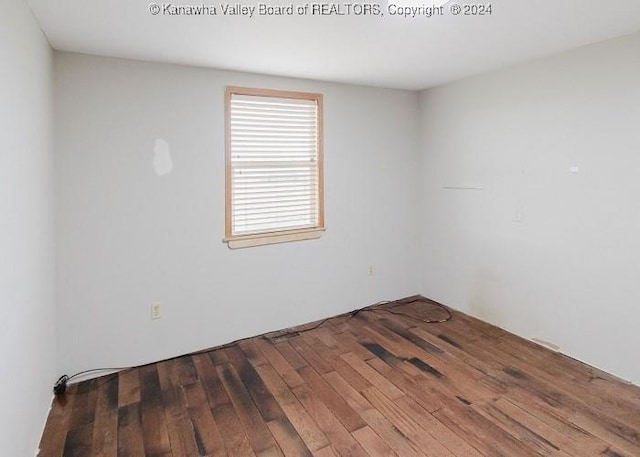 spare room featuring dark hardwood / wood-style floors