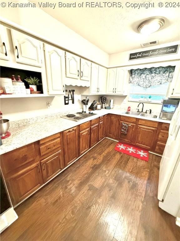 kitchen with white cooktop, sink, and dark wood-type flooring