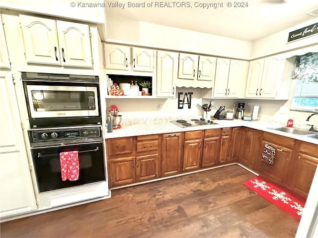 kitchen featuring white gas stovetop, sink, dark hardwood / wood-style floors, oven, and stainless steel microwave