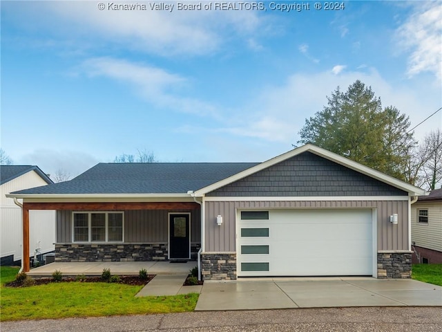 view of front of property featuring covered porch and a garage