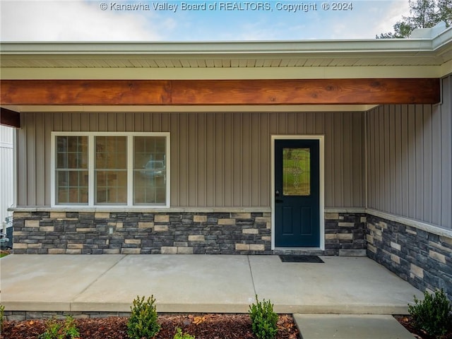 view of exterior entry with covered porch