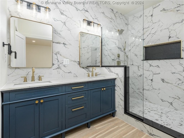 bathroom with vanity, hardwood / wood-style flooring, walk in shower, and tile walls