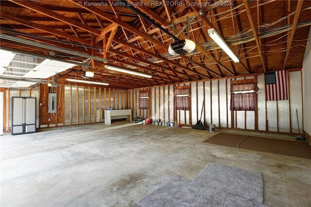 garage featuring a garage door opener and electric panel