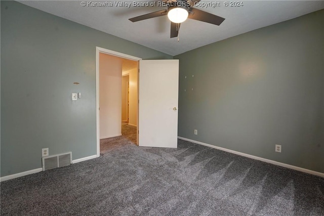 carpeted spare room featuring ceiling fan