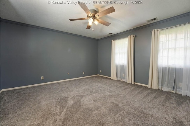 carpeted spare room featuring crown molding and ceiling fan