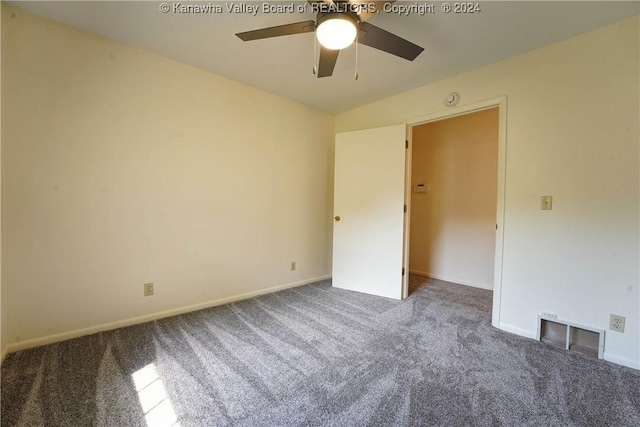 carpeted spare room featuring ceiling fan