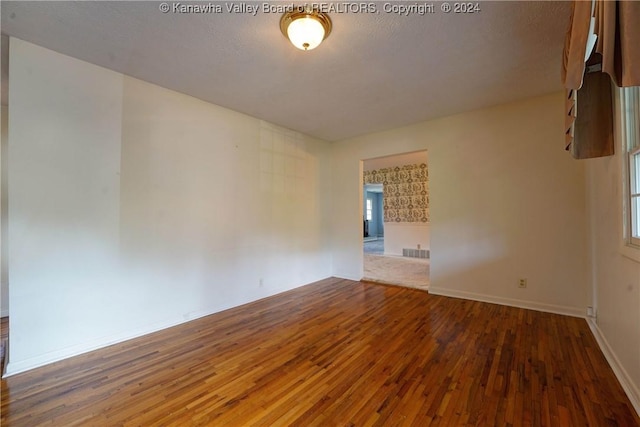 empty room featuring wood-type flooring