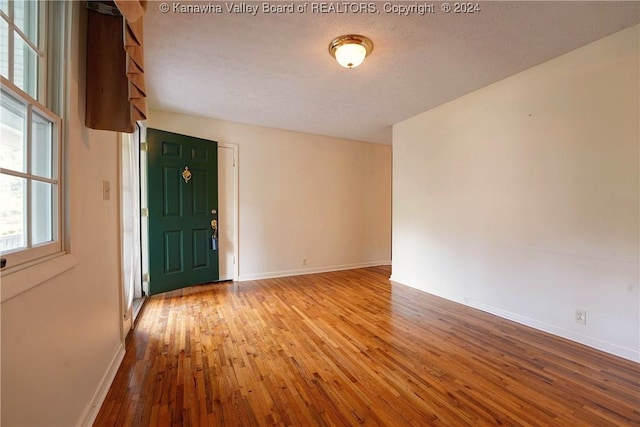 interior space featuring a textured ceiling and light wood-type flooring