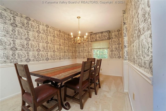 dining area featuring light colored carpet and an inviting chandelier