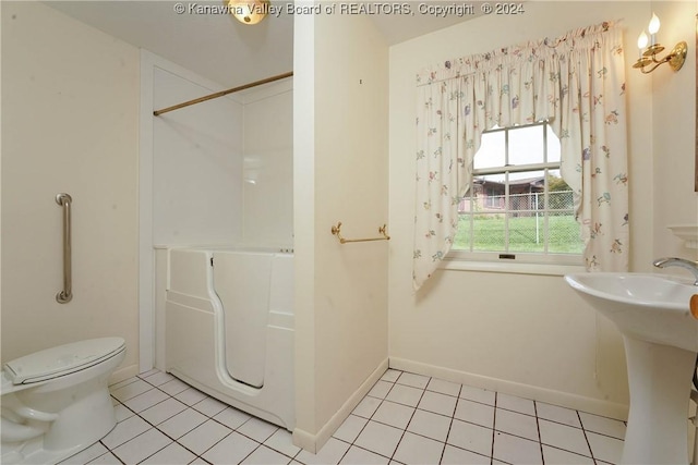 bathroom with tile patterned flooring, toilet, and sink