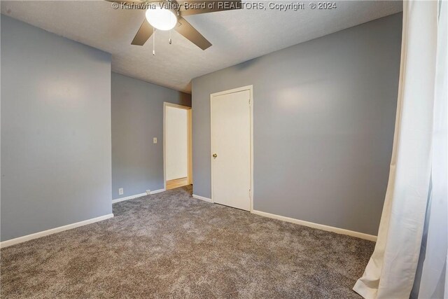 empty room with carpet flooring and ceiling fan