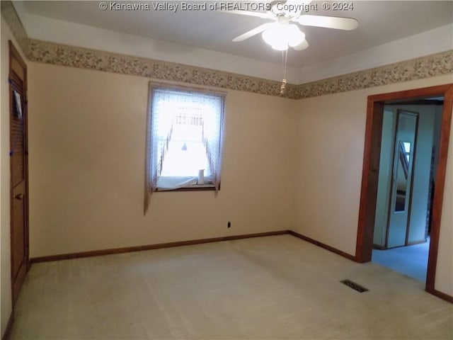 carpeted empty room with ceiling fan