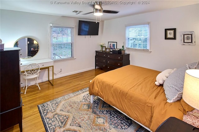 bedroom with ceiling fan and light hardwood / wood-style floors