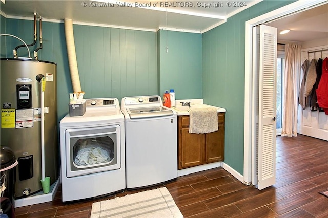 laundry area with washer and clothes dryer, crown molding, electric water heater, and dark wood-type flooring