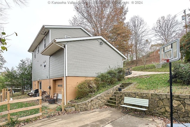 view of side of property with a patio