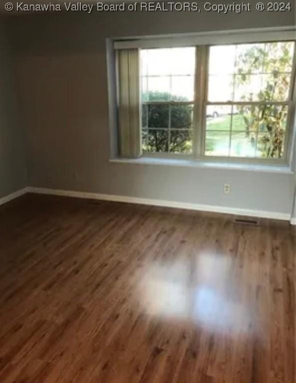 spare room featuring dark hardwood / wood-style flooring