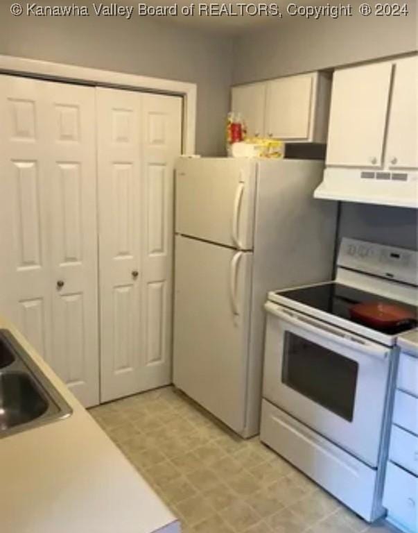 kitchen with white cabinetry, white appliances, sink, and extractor fan