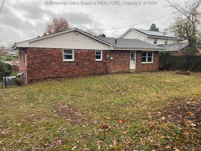 rear view of house with a lawn