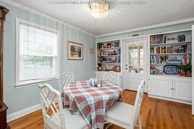 dining space featuring hardwood / wood-style floors, crown molding, and a wealth of natural light