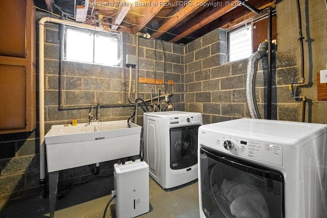 washroom with washer and dryer and sink