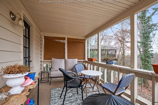 sunroom featuring plenty of natural light and wood ceiling