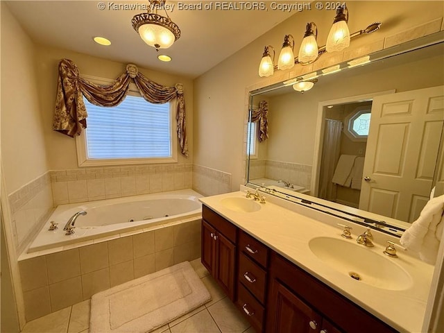 bathroom featuring tile patterned flooring, vanity, and a relaxing tiled tub