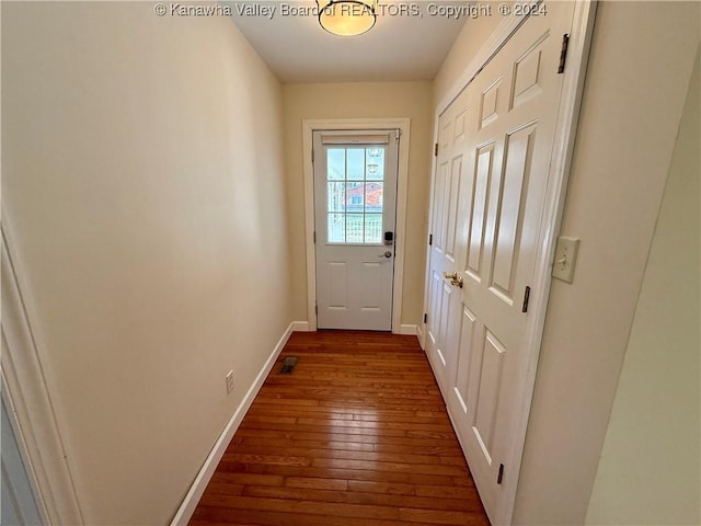 doorway to outside with dark wood-type flooring