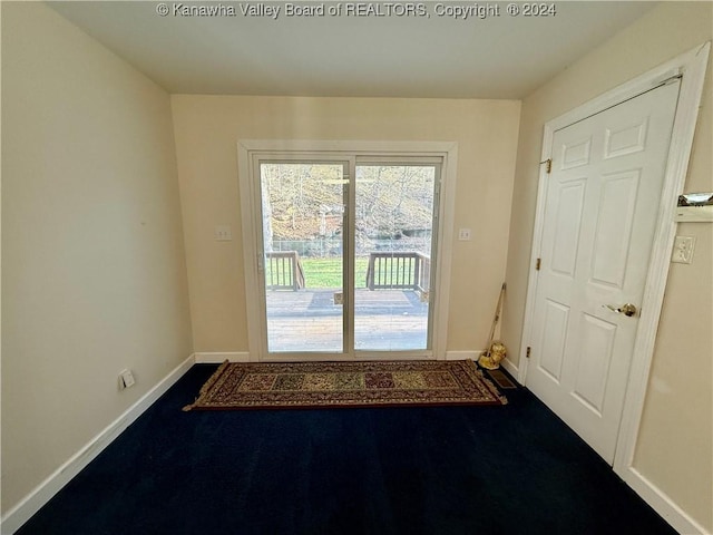 doorway with dark carpet