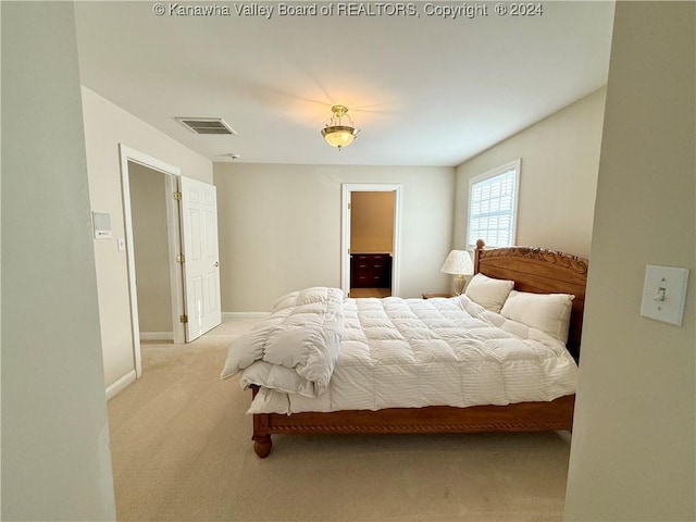 bedroom with light colored carpet