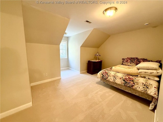 carpeted bedroom featuring vaulted ceiling