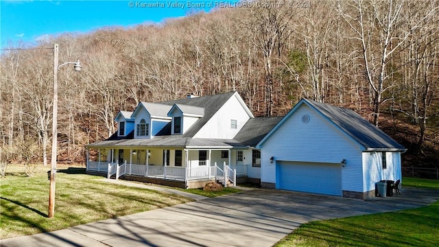 view of front of house featuring a porch, a garage, and a front yard