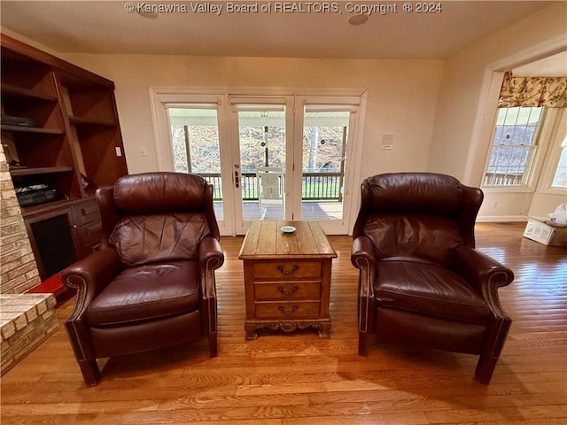 sitting room with french doors and light hardwood / wood-style floors