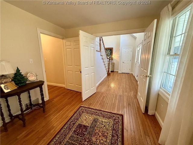 hallway featuring plenty of natural light and hardwood / wood-style flooring