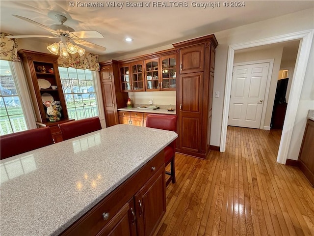 kitchen with light hardwood / wood-style floors and ceiling fan