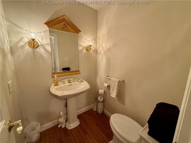 bathroom featuring hardwood / wood-style flooring and toilet