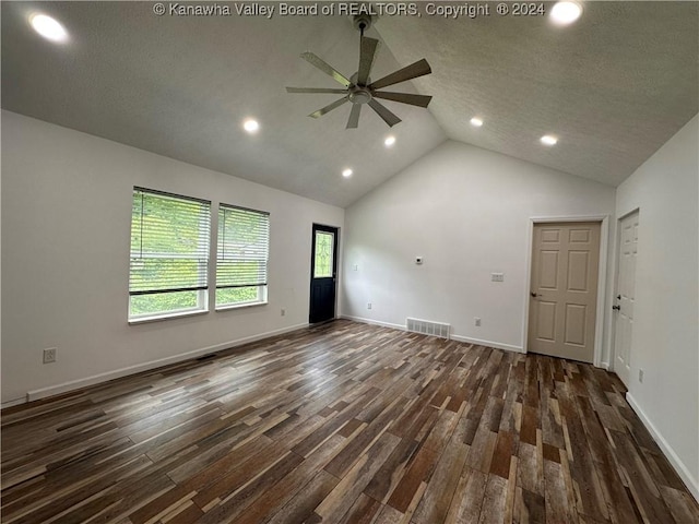 empty room featuring dark hardwood / wood-style floors, ceiling fan, and a textured ceiling