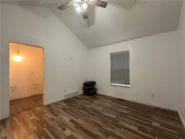 empty room featuring high vaulted ceiling, ceiling fan, and dark wood-type flooring