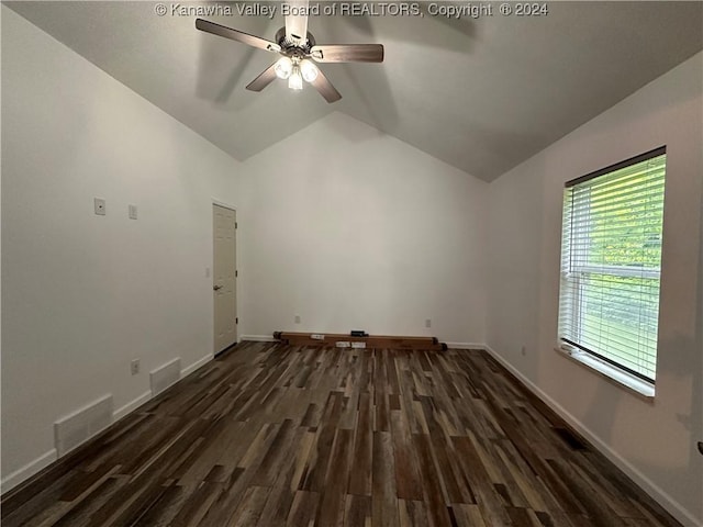 empty room with dark hardwood / wood-style floors, ceiling fan, and lofted ceiling