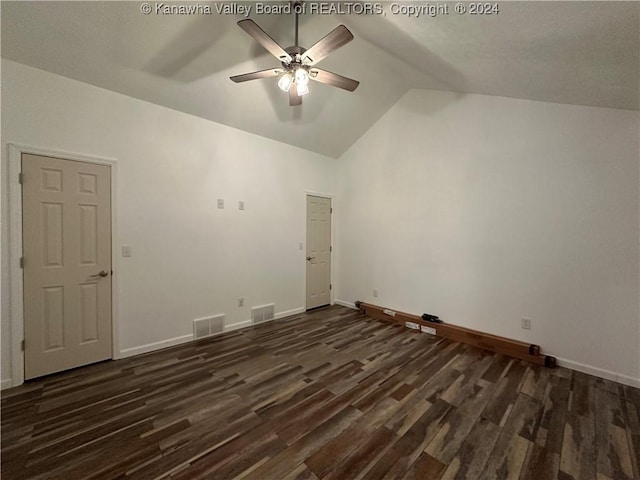 spare room featuring vaulted ceiling, ceiling fan, and dark wood-type flooring