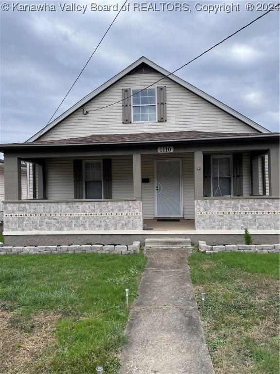 view of front of home featuring a porch and a front lawn