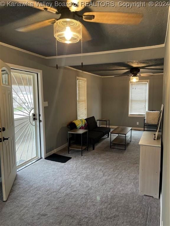 carpeted living room with ceiling fan and ornamental molding