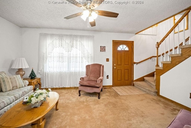 living room with light carpet, a textured ceiling, and ceiling fan