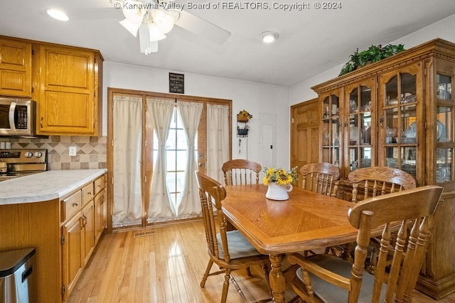 dining space featuring ceiling fan and light hardwood / wood-style floors