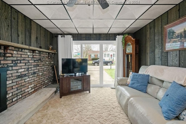 carpeted living room featuring a paneled ceiling and ceiling fan