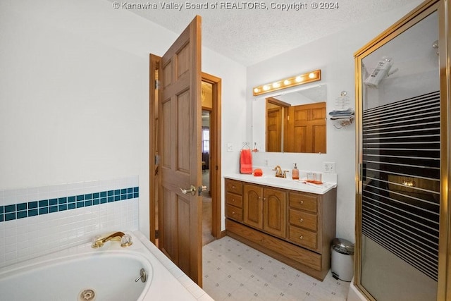 bathroom featuring vanity, a textured ceiling, and shower with separate bathtub