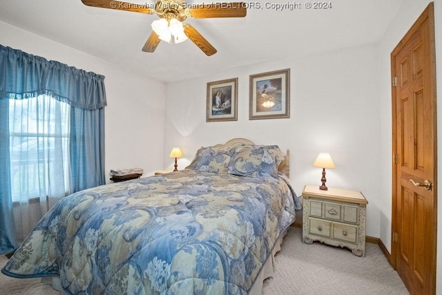 bedroom with ceiling fan and light colored carpet