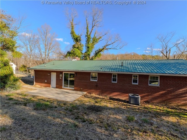 back of house with central air condition unit and a patio area